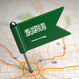 Saudi Arabia Small Flag on a Map Background.