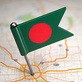 Bangladesh Small Flag on a Map Background.