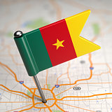 Cameroon Small Flag on a Map Background.