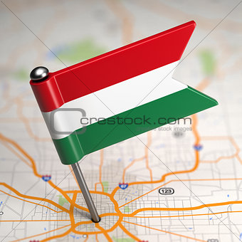 Hungary Small Flag on a Map Background.