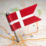 Denmark Small Flag on a Map Background.
