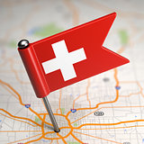 Switzerland Small Flag on a Map Background.