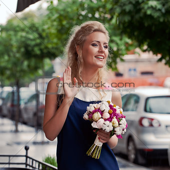 a beautiful young girl in summer dress with a bunch of flowers i