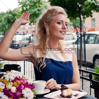 a beautiful young blond girl in summer dress at the table in pav