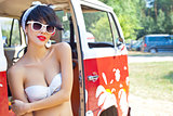 a beautiful retro-looking girl with red lips in sunglasses  