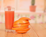 Glass of juice, grapefruit sliced ​​rings and stacked