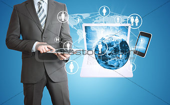 Man holding tablet. Near the earth and electronics