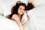 Woman laid in bed looking up