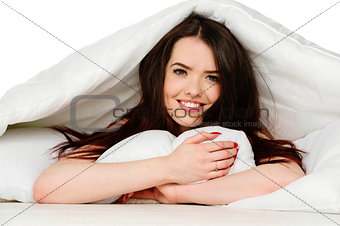 Woman laid in bed smiling