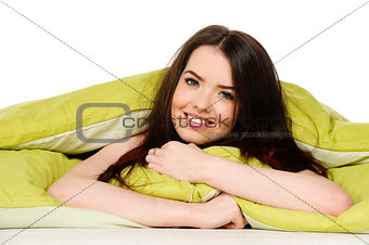 Woman laid in a green bed smiling