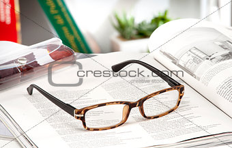 reading glasses endorsed on a magazine at home