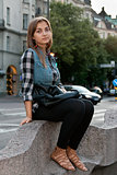 girl sitting on a street