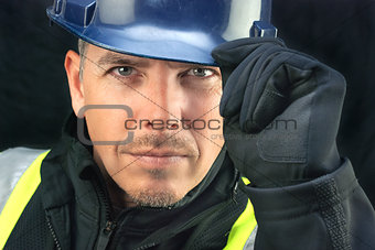 Construction Worker Putting On HardHat