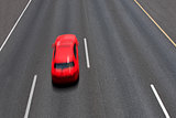 Red car moves fast on empty multilane highway ( long exposure, motion blurred, view from above).