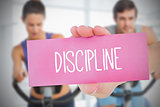 Woman holding pink card saying discipline