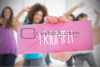Woman holding pink card saying triumph