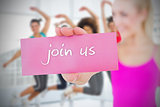 Fit blonde holding card saying join us