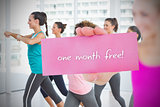 Fit blonde holding card saying one month free