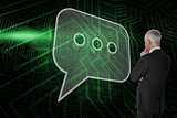 Composite image of speech bubble and businessman looking