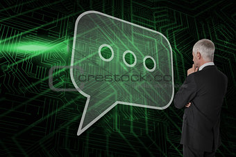 Composite image of speech bubble and businessman looking