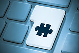Composite image of jigsaw piece on enter key