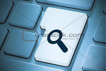 Composite image of magnifying glass on enter key