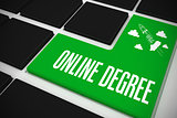 Online degree on black keyboard with green key