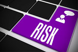 Risk on black keyboard with purple key