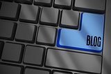 Blog on black keyboard with blue key