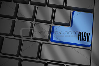 Risk on black keyboard with blue key