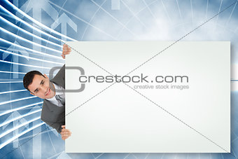 Composite image of businessman showing card