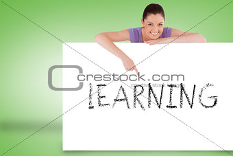 Pretty brunette showing card with learning