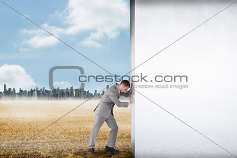 Composite image of businessman pushing away scene