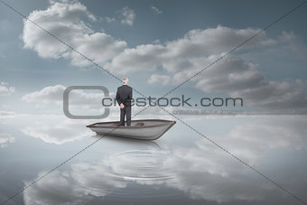 Composite image of rear view of mature businessman posing in a sailboat