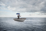 Composite image of peaceful businessman holding blue umbrella in a sailboat