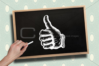 Composite image of hand drawing thumbs up with chalk