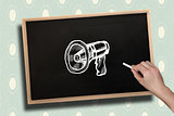 Composite image of hand drawing megaphone with chalk