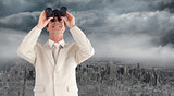 Composite image of confident businessman with binoculars