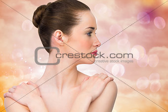 Composite image of beautiful brunette with arms over chest