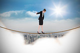 Composite image of businesswoman performing a balancing act