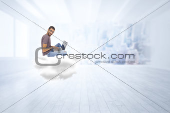 Composite image of man wearing glasses sitting on cloud using laptop and looking at camera