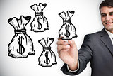 Composite image of businessman drawing money bags