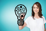 Composite image of businesswoman drawing light bulb