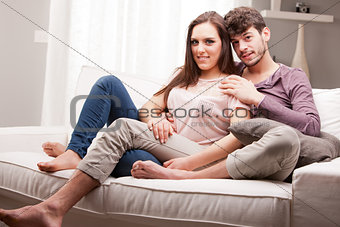 couple of lovers in relax glaze on a sofa