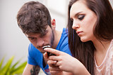 woman ignores man texting with her mobile