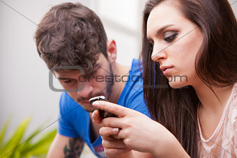 woman ignores man texting with her mobile