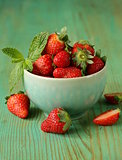 fresh sweet ripe strawberries in a bowl on a wooden table