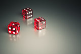 three dice in the corner on a silver table
