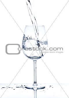 Glass with the stream of dinking water
