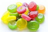 colored caramel fruit candies on a white background